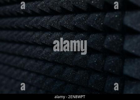 black geometric pyramidal background walls made of sound-proof foam rubber Stock Photo