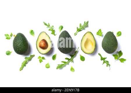 Fresh avocados pieces with green leaves Isolated  on white background. Flat lay. Stock Photo