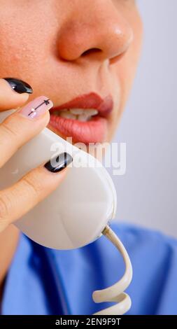 Close up of medical receptionist answering phone calls from patient in hospital making appointment. Healthcare physician in medicine uniform, doctor assistant helping with telehealth communication Stock Photo