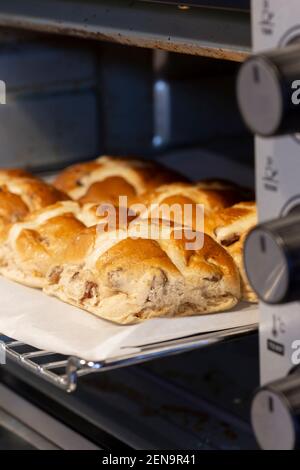 Hot cross buns cooked in an electric oven.  Easter food concept Stock Photo
