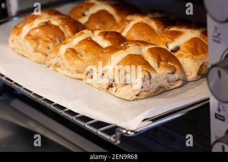 Hot cross buns cooked in an electric oven.  Easter food concept Stock Photo
