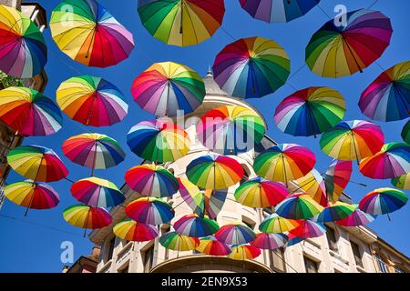 Floating colorful umbrelas are decortating Rue Carnot in the center of Gap. Hautes-Alpes (05), France Stock Photo