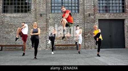 Group of people warming up and doing exercises, body workout concept Stock Photo