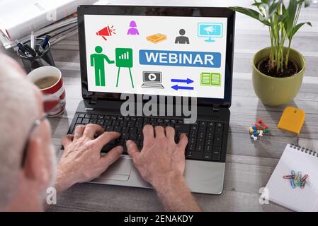 Webinar concept shown on a laptop used by a man Stock Photo