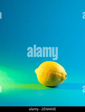 Lemon on a bright background. Vitamin C. Creative summer minimalistic background. Copy space Stock Photo