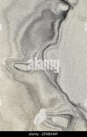 Dark patterns in the sand Stock Photo