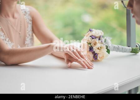 Woman Holds Out a Bouquet Wrapped in Black Paper, Covering Her