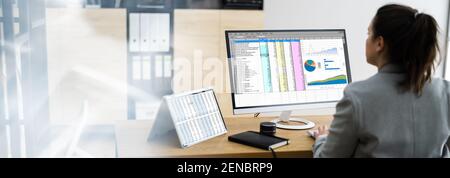 Woman Using Finance Spreadsheet Report On Laptop Screen Stock Photo
