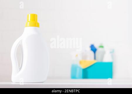 White chlorine bottle with yellow cover mock-up. Toxic detergent. Cleaning supplies in background. Cleaning and hygiene concept.  Stock Photo