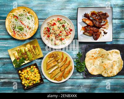 Lemon Chicken, Cucumber Salad, Special Fried Rice, Barbecued Char Sui Pork with Sticky Sauce, Asian Shredded Noodle Salad with Mango Relish Stock Photo