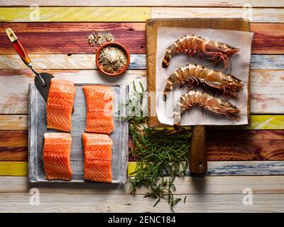 Raw Fillets of Salmon, Large King Prawns and Samphire Stock Photo