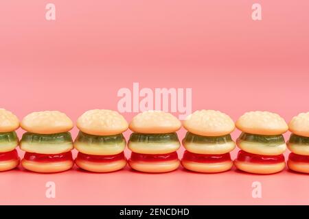 Colorful candy hamburgers on pink background. Minimal food concept. Stock Photo