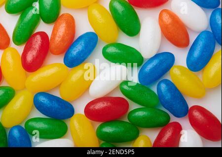Multicolored oval candy background on white backdrop Stock Photo