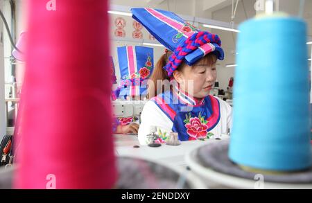 Shaanxi,CHINA-Embroidery women rush to produce qiang embroidery products in  Ningqiang county, Hanzhong city, Shaanxi province, July 29, 2019. Qiang  embroidery is Qiang folk arts and crafts, women in labor clearance  completed they
