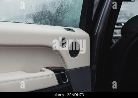 inside car door with beige and black leather Stock Photo