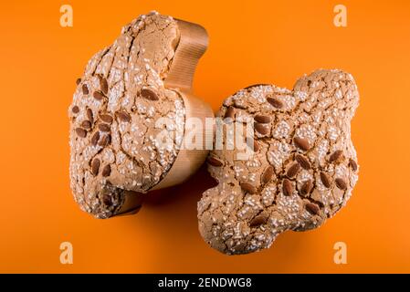 Colomba Pasquale, traditional Italian Easter dove with glazed sugar and almonds on top. two cakes isolated on orange background Stock Photo