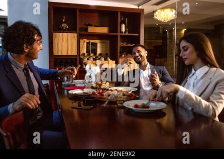 Successful people having dinner in peace and enjoying themselves Stock Photo