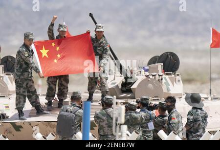 Chinese soldiers pose for photos with national flag in a tank during a  competition at the opening ceremony of the International Army Games 2019 in  Korla city, northwest China's Xinjiang Uygur Autonomous