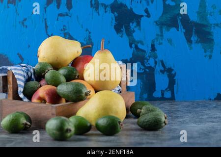 Close up photo of Fresh fruit basket. Different fruits . Acca, peach and pear Stock Photo