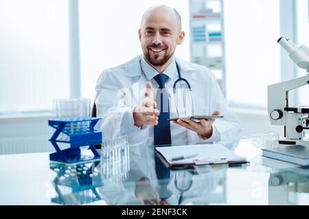 smiling young scientist works in a laboratory. Stock Photo