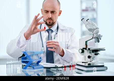 close-up. researcher sitting at a table in a medical laboratory. Stock Photo