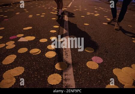 A shadow of a protester using a laser pointer while paper money