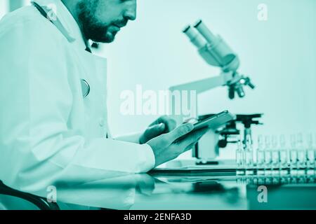 scientist using a digital tablet while working in the lab. Stock Photo