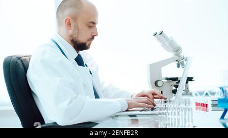scientist using a laptop in a medical lab. Stock Photo