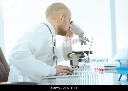 scientist examining blood samples in a lab. side view. Stock Photo