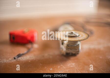 Grinding tool with abrasive cutting wheel on the dirty floor Stock Photo