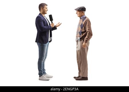 Young male reporter interviewing an elderly man isolated on white background Stock Photo