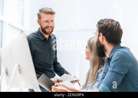 young woman discussing business matters with her colleagues Stock Photo