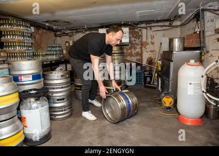 Sean Hughes landlord of 'Dylans' pub in St Albans prepares casks of beer for reopening his pub after the coronavirus lockdown#3 is lifted in England. Stock Photo