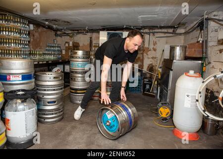 Sean Hughes landlord of 'Dylans' pub in St Albans prepares casks of beer for reopening his pub after the coronavirus lockdown#3 is lifted in England. Stock Photo