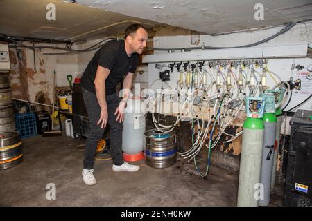 Sean Hughes landlord of 'Dylans' pub in St Albans prepares casks of beer for reopening his pub after the coronavirus lockdown#3 is lifted in England. Stock Photo