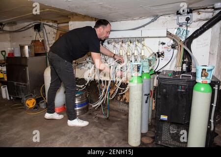 Sean Hughes landlord of 'Dylans' pub in St Albans prepares casks of beer for reopening his pub after the coronavirus lockdown#3 is lifted in England. Stock Photo