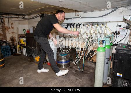 Sean Hughes landlord of 'Dylans' pub in St Albans prepares casks of beer for reopening his pub after the coronavirus lockdown#3 is lifted in England. Stock Photo