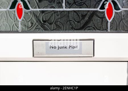 A sign on the letter box of a front door that reads no junk mail Stock Photo