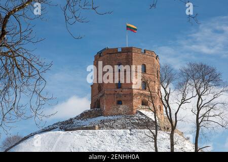 Gediminas Tower is the remaining part of the Upper Castle in Vilnius, Lithuania with Lithuanian flag in winter day Stock Photo