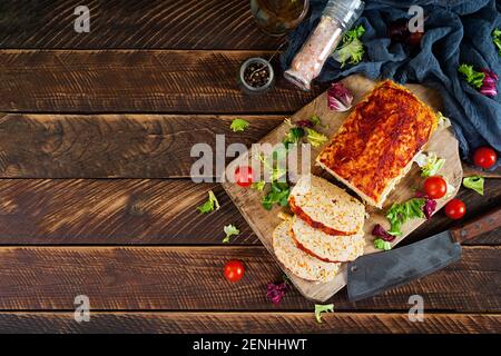 American meatloaf with chicken meat, pumpkin and green peas. Baked minced chicken meat. Top view Stock Photo