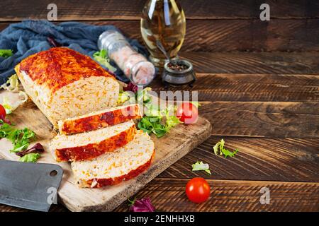 American meatloaf with chicken meat, pumpkin and green peas. Baked minced chicken meat Stock Photo