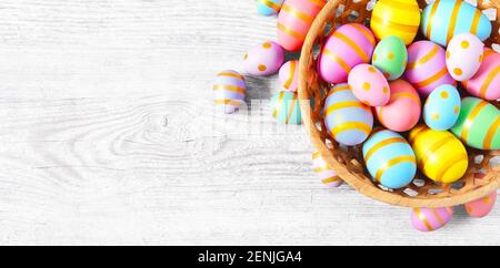 Happy Easter wooden background with pink, yellow and blue eggs. Gift card with colorful easter eggs on white wooden table. Stock Photo