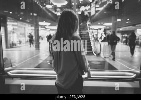Girl in lift in a large shopping center. Stock Photo