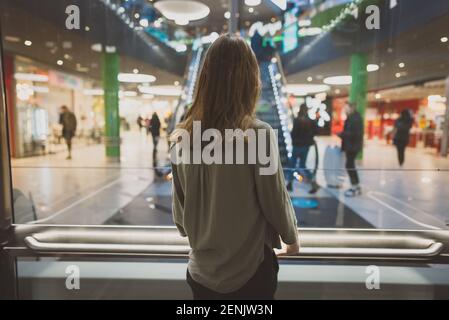Girl in lift in a large shopping center. Stock Photo