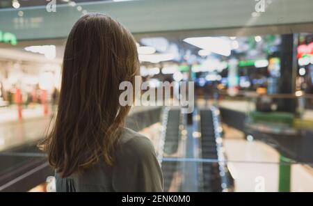 Girl in lift in a large shopping center. Stock Photo