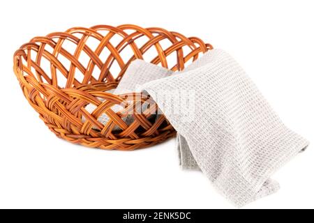Empty wicker basket and gray towel isolated on white background. Stock Photo