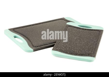 Two black plastic cutting boards isolated on white background. Stock Photo