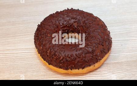 Donut with chocolate icing on the table. Delicious food, pastries Stock Photo