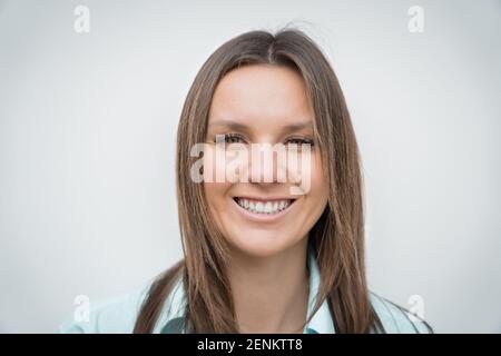 Close up portrait of young cheerful happy smiling business woman with white perfect smile looking at the camera Stock Photo