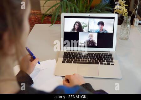 Woman having video call with colleagues Stock Photo